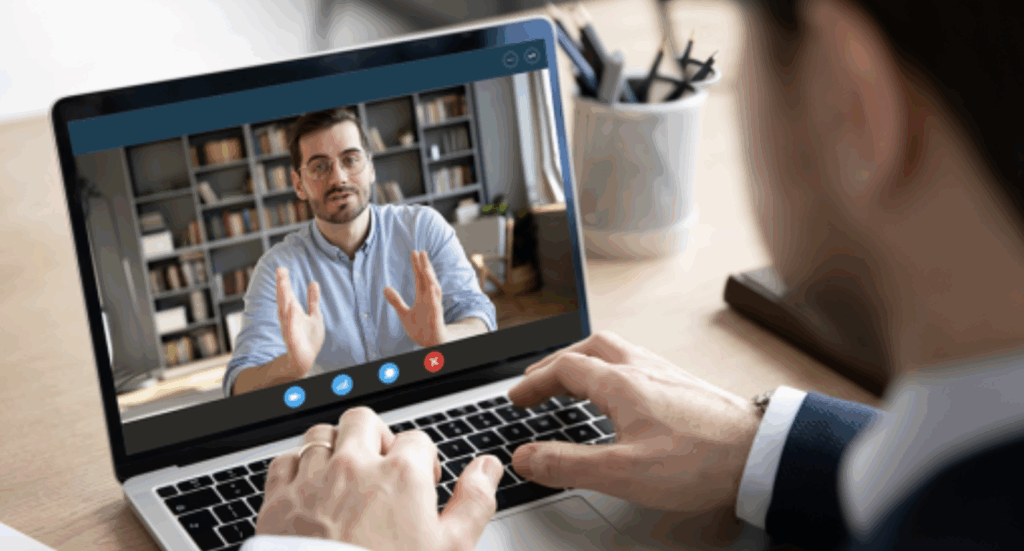 Video call on laptop with male participant.